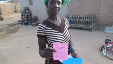 Mother holding her child measles vaccination card