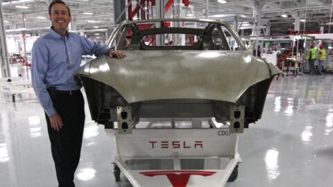 A Tesla vehicle body on a factory floor